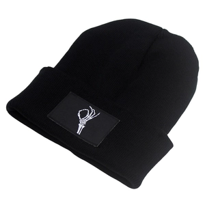 Black knit beanie with skeletal OK hand embroidery on a white background