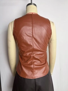 Detail view of the vintage brown PU leather vest back with center seam and slim fit tailoring