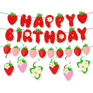 Flat lay of strawberry theme Happy Birthday banner with matching flower party pendants