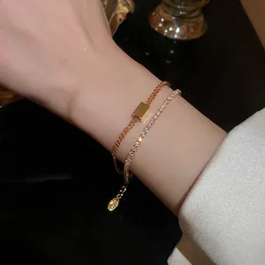 Double-layer gold plated bracelet with square slider and pave cubic zirconia on wrist