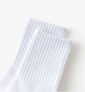 Close-up of the ribbed cuff on breathable white cotton crew socks for children