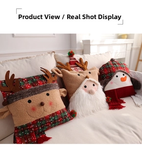 Detailed view of Christmas pillows featuring Santa, reindeer, and snowman on a sofa