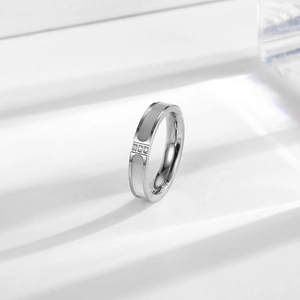 Minimalist titanium steel ring with white shell inlay and three small vertical diamonds