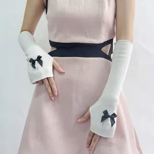 White knit arm sleeves with black bows and pearl pendants for sweet JK style look