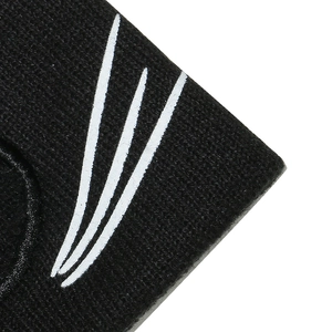 Detailed macro shot of black knitted beanie with white cat whisker graphic print