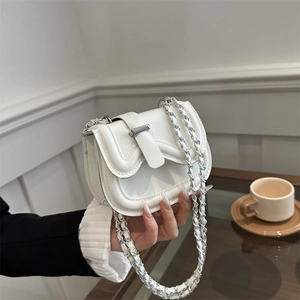 Minimalist white leather saddle crossbody bag with silver chain strap and metal buckle