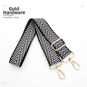 Close-up of adjustable chevron canvas bag strap with gold metal lobster clasps