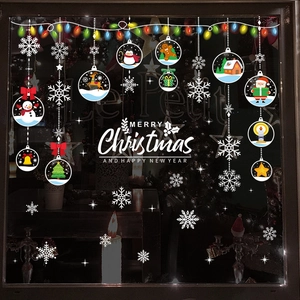 Christmas window stickers featuring Santa, snowman, and reindeer on shop glass