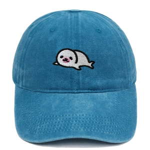 Detailed embroidery of a cute cartoon seal on a navy blue washed cotton baseball cap