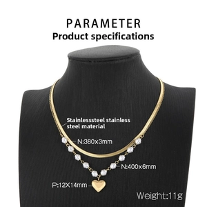 Double-layered gold necklace with flat snake chain, pearl beads and heart pendant