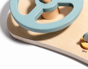 Close-up of wooden sensory steering wheel with blue wheel and yellow toggle switch