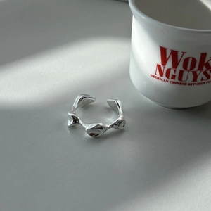 Macro shot of S925 sterling silver irregular wavy ring showing the inside hallmark