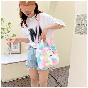 Detail of plush rainbow unicorn bag with embroidery and adjustable pink strap