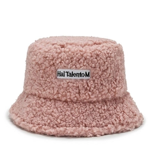 Close-up of pink lamb wool bucket hat featuring soft plush texture and white logo tag