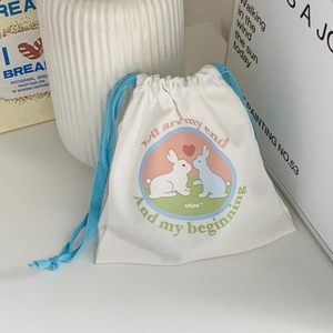 Detailed view of canvas drawstring bag with cute rabbit print and romantic typography