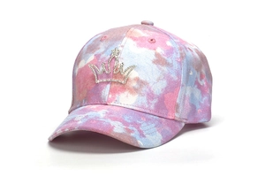 Detailed side view of tie-dye glitter baseball cap with rhinestone crown emblem