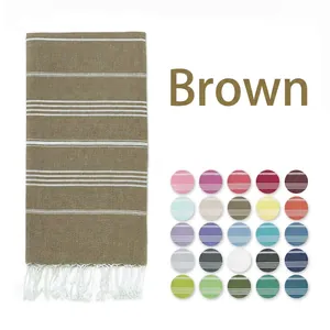 Brown striped Turkish beach towel detail with white tassels and multiple color swatches