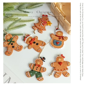 Set of six resin gingerbread man ornaments with festive decorations and hanging ropes