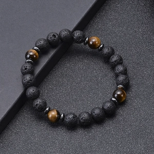 Close-up of 8mm black lava stone and brown tiger eye beads on a minimalist bracelet