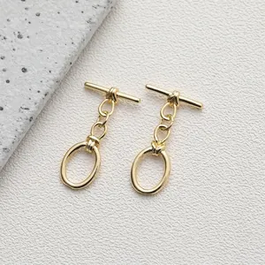 Macro shot of 14K gold plated OT toggle clasps for DIY jewelry making on stone background