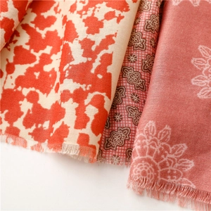 Close-up of three floral cotton scarves with fringe details in various patterns