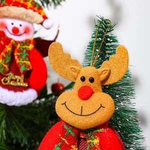 Close-up of reindeer and snowman plush ornaments with Merry Christmas sign for tree