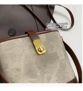 Close-up of golden metallic vertical stripe lock on fabric bucket bag with leather trim