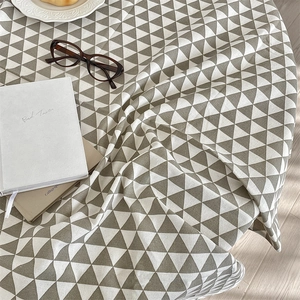 Detail of minimalist geometric triangle pattern tablecloth in cotton linen fabric
