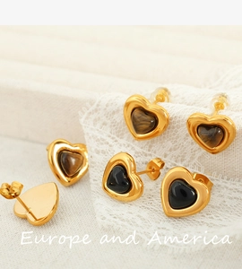 Macro view of French vintage heart studs with tiger eye stone and gold metal frame