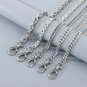 Stainless steel skull clasp pant chains with Byzantine and Cuban link styles on a prop