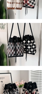 Close-up of knit bucket bag with wave patterns, drawstring closure and shoulder strap