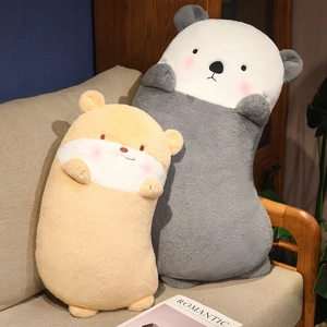 Plush otter pillow in grey and yellow soft fabric on a sofa, long stuffed animal dolls