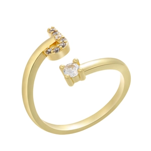 Macro detail of gold-plated open ring with micro-paved letter J and a solitaire cubic zirconia