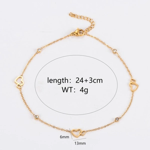 Golden heart charm anklet with rhinestones and hollow heart pendants on a white background