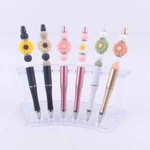 Detail of DIY beaded pens with silicone sunflower charms and sparkling rhinestone accents
