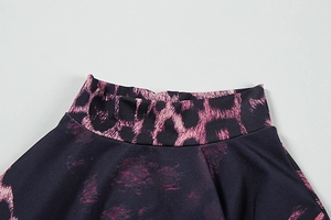 Detail of high mock neck and purple leopard print texture on a long sleeve dress