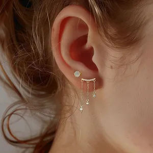 Close-up of 925 sterling silver star and moon tassel earrings set with zircon accents