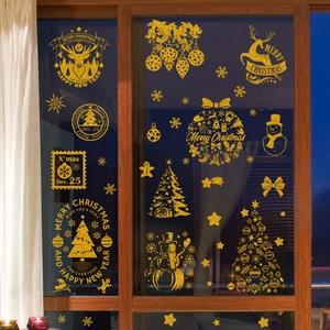 Detail of glitter gold Santa and reindeer window stickers for Christmas home decoration