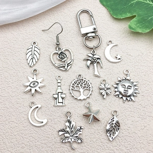Silver alloy DIY charm set featuring moon, sun, tree and star pendants for jewelry making