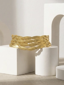 Detailed close-up of 18K gold plated multi-layer braided blade chain bracelet texture