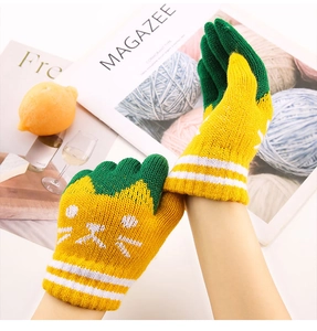 Close-up of knit texture and cute cartoon cat pattern on children's winter warm gloves