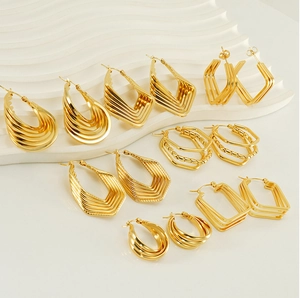 Macro shot of assorted gold geometric chunky hoop earrings set with textured details