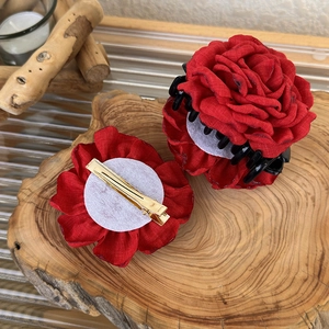 Detail of red fabric rose hair clips set including a shark claw and a metal duckbill clip