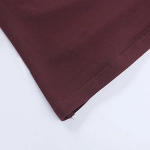 Close-up of the burgundy knitted fabric showing detailed stitching and seam quality