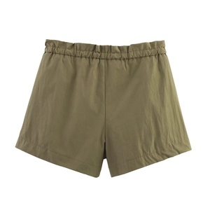 Detail view of olive green casual shorts featuring elastic waistband and smooth fabric texture
