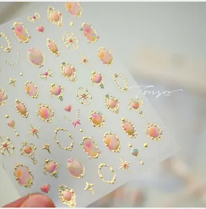 Detail of vintage French embossed nail stickers with gold frame and purple gemstone designs
