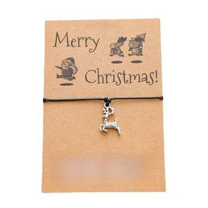 Detail of Christmas wish bracelet with silver elk pendant on card stock packaging
