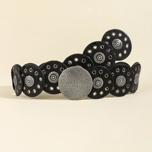 Close-up of vintage baroque belt with black leather discs and hammered silver buckle