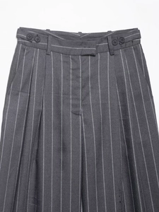Detail of grey pinstripe trousers showing waist belt loops and double button closure