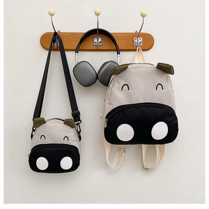 Detail of cute hippo cartoon canvas backpack and matching small crossbody bag